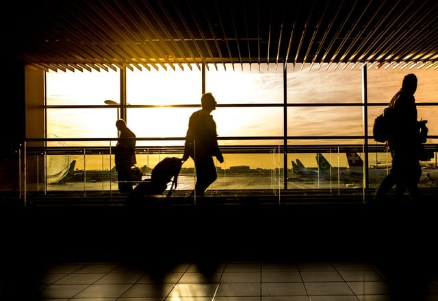 Man with hearing loss rolling luggage 