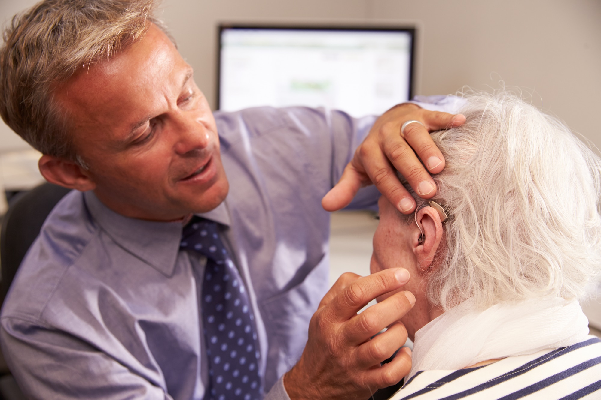 man having his hearing aid fit