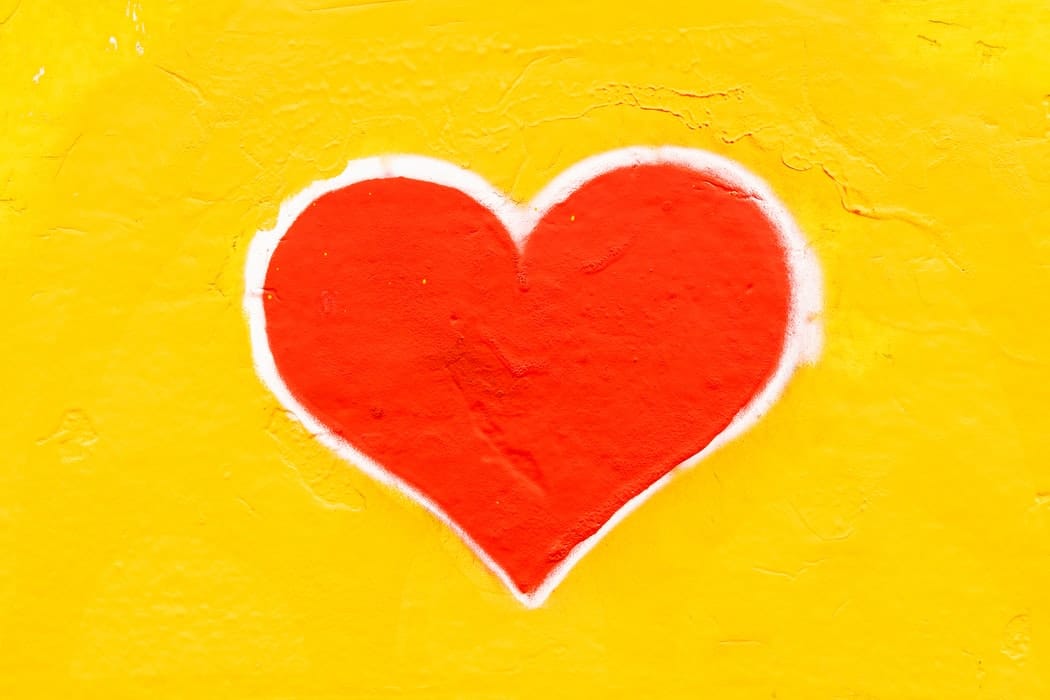 A red heart on a yellow background.