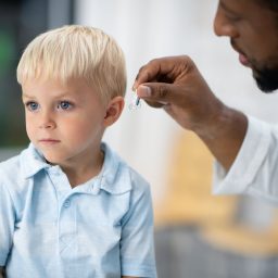 A child being fitted for a hearing aid.