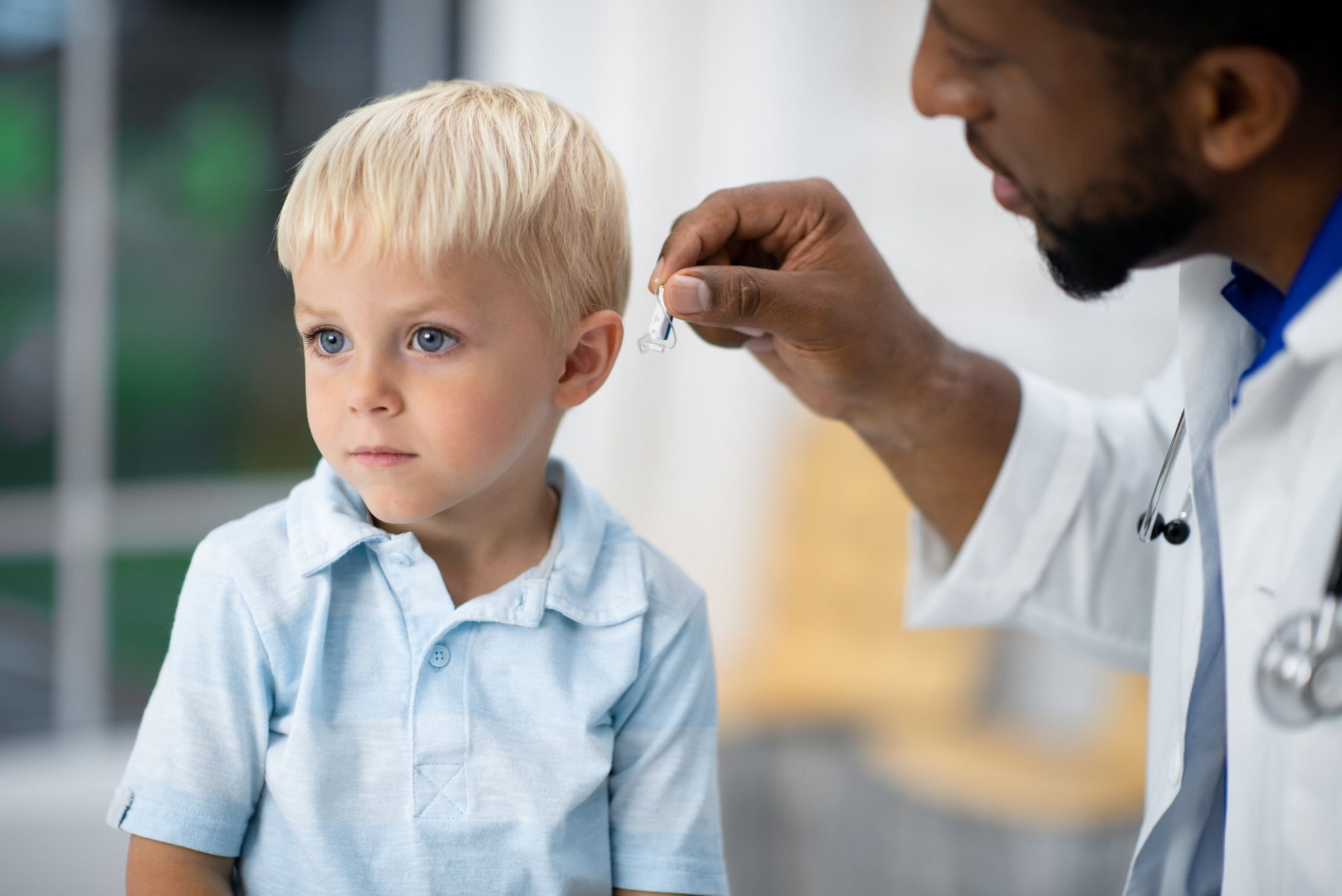 A child being fitted for a hearing aid.